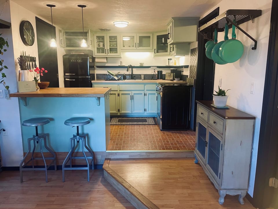 Cozy kitchen with fridge electric stove and range and dishwasher. 