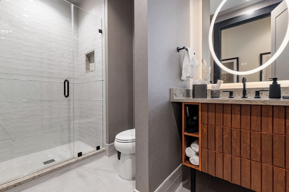 Bathroom 1 - Contemporary bathroom with ambient lighting and complimentary toiletries—ideal for unwinding after a day of exploring the city.