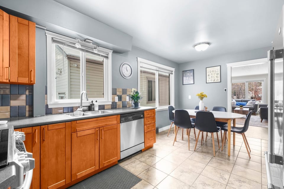 Bright dining area with a modern table for four, set beside large windows