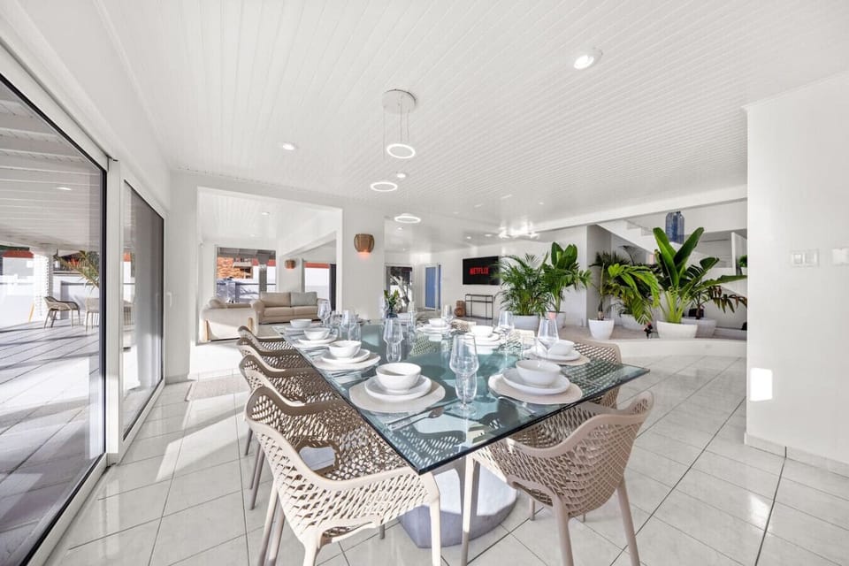 This inviting area is ideal for shared meals, lively conversations, or hosting elegant dinner parties. The table is fully set with complete cutlery and fine china, adding a touch of sophistication to every dining experience.