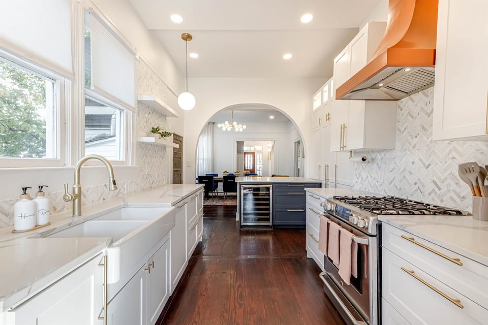 Enjoy a stunning view of the kitchen from the door leading to the backyard, showcasing modern finishes and an open, inviting layout.