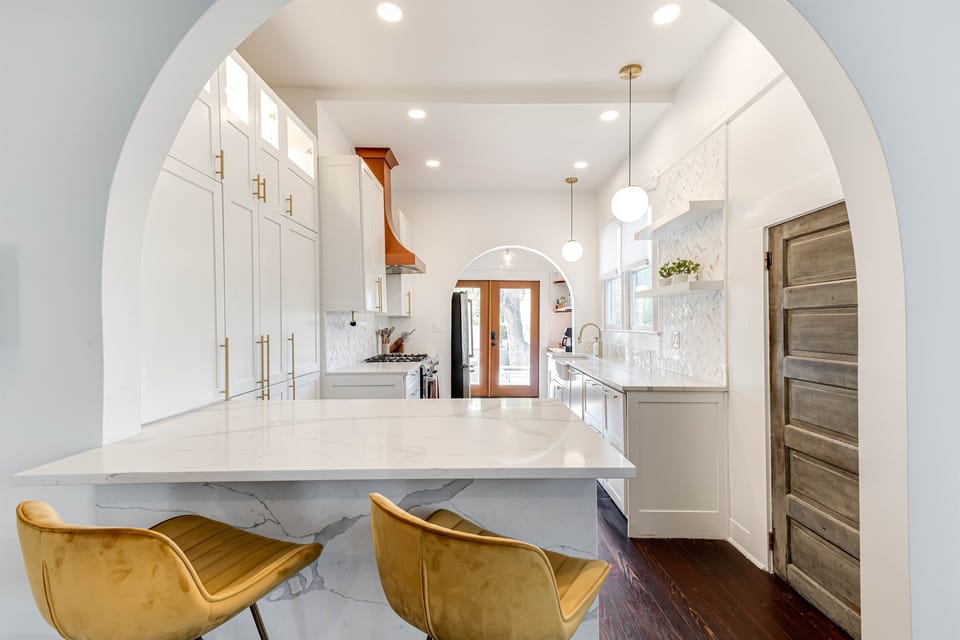 An elegant kitchen with modern finishes, featuring a seamless flow to the backyard.