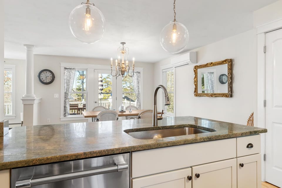 A bright and elegant kitchen with a granite island.