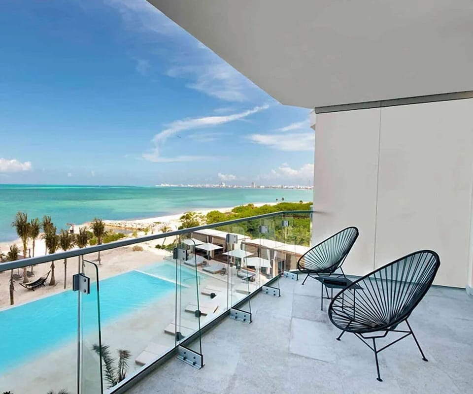 Breathe in turquoise horizons from your private beachfront balcony.