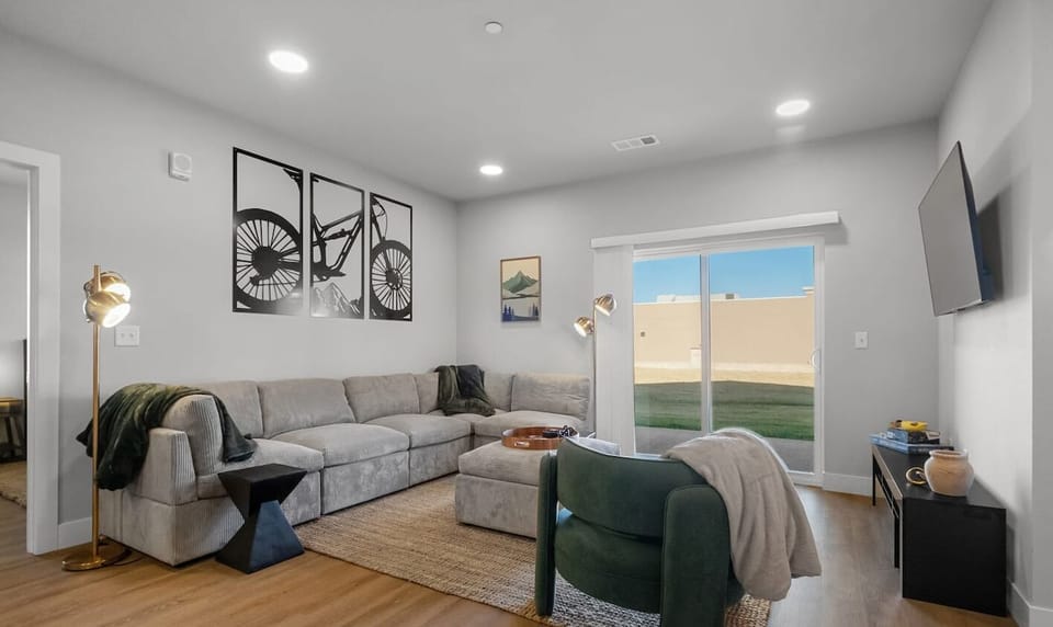 Step into the inviting open-concept living space, flooded with natural light. The contemporary decor and plush furnishings create a warm atmosphere, perfect for relaxing after a day of exploring. This sectional can convert to sleep 2 comfortably.