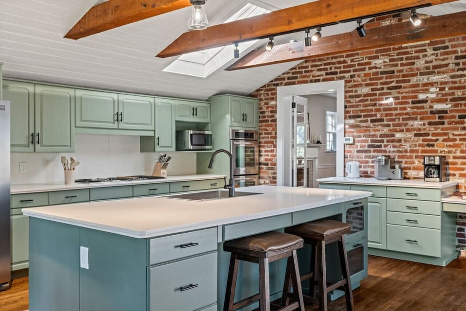 A chef’s dream! Modern, open-concept kitchen featuring premium appliances and a massive quartz island.