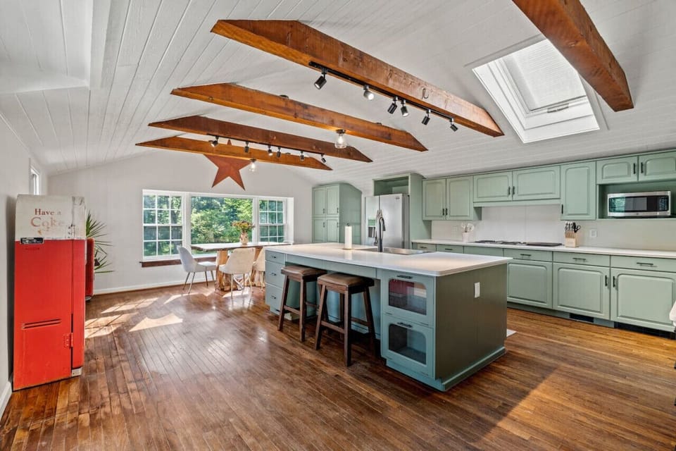 Farmhouse-inspired kitchen with custom cabinetry and beams