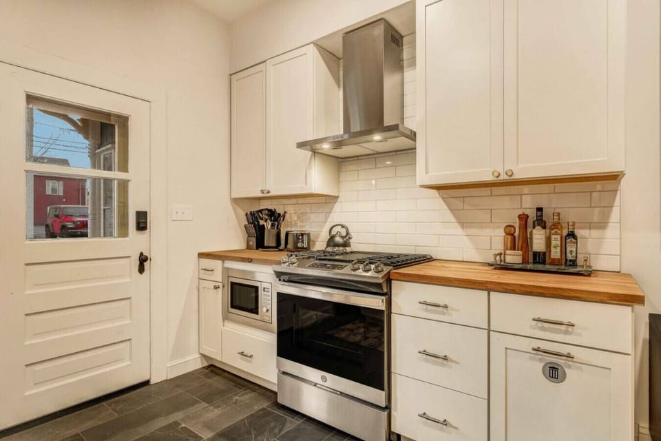 Cook your favorite meals with ease using the modern stove and oven, ready for all your culinary creations.