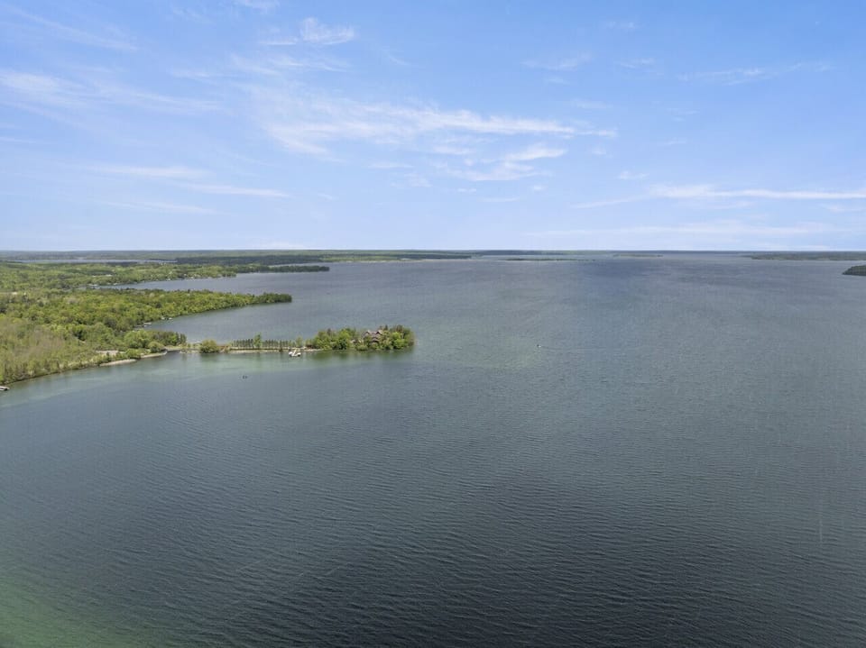 Panoramic waterfront view offering clear skies and deep blue water.