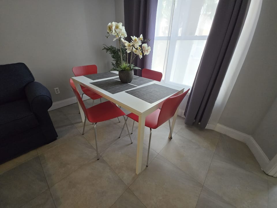 Bright and welcoming table for four—perfect for meals or game nights.