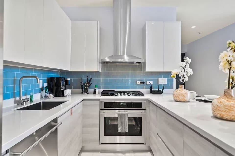 Cook with ease in a sleek, fully equipped kitchen with modern appliances, a gas range, and a cozy coffee bar—perfect for relaxed meals and easy mornings.