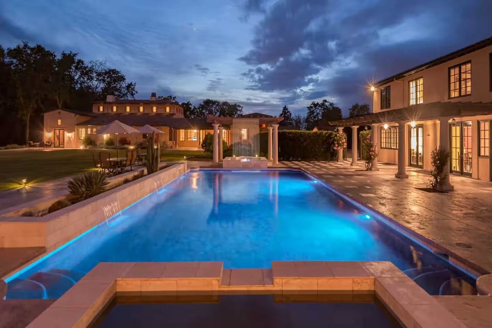 Pool area, perfectly illuminated and surreal under the evening sky