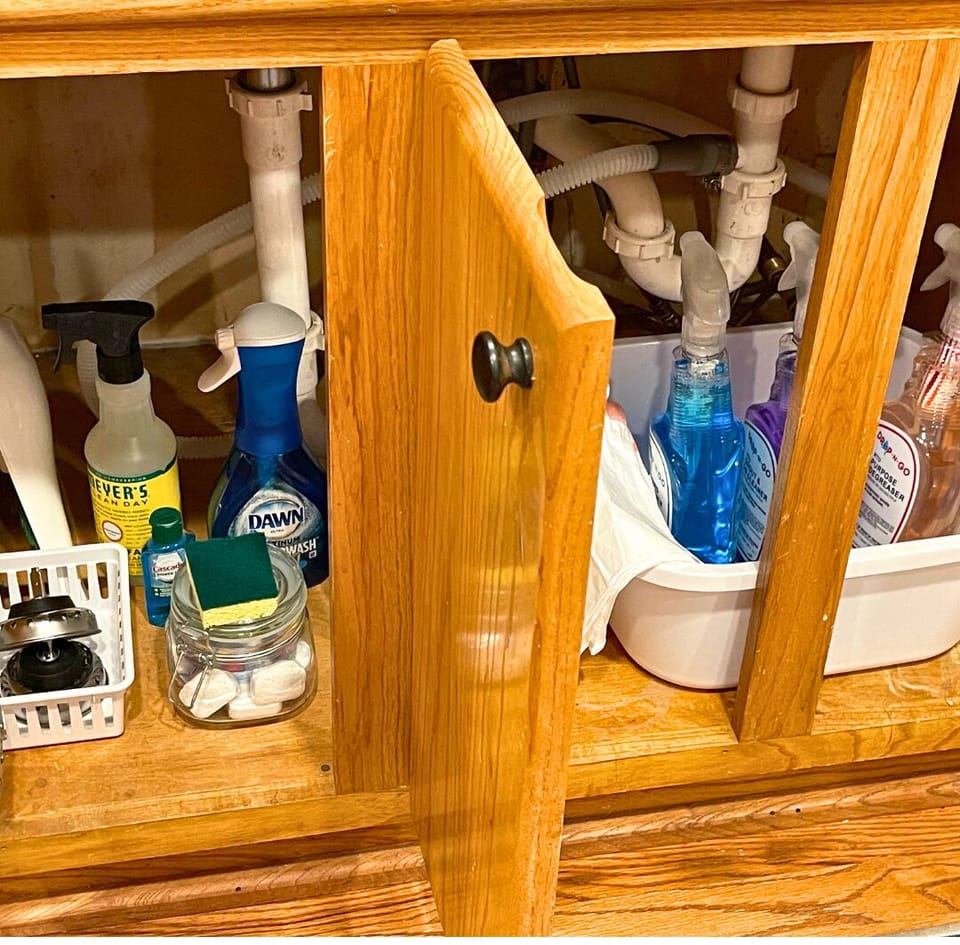Under the kitchen sink, your go-to spot for keeping things tidy, just like Coach Jacobs would’ve liked it.