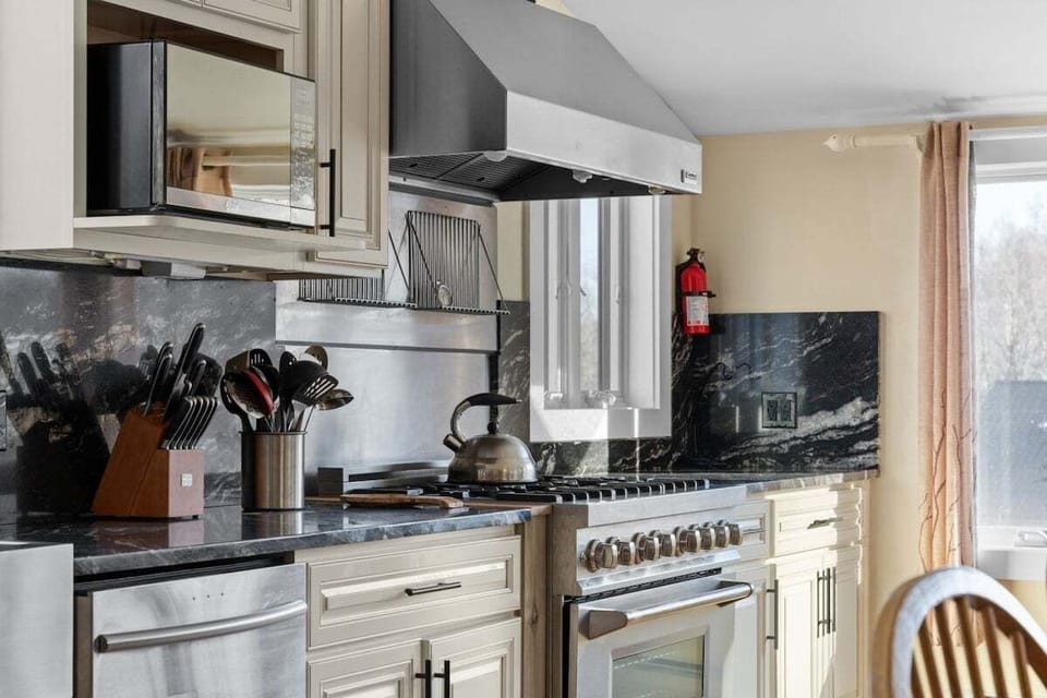 A broad range, nearby dishwasher, and generous counters provide cooks room to work.
