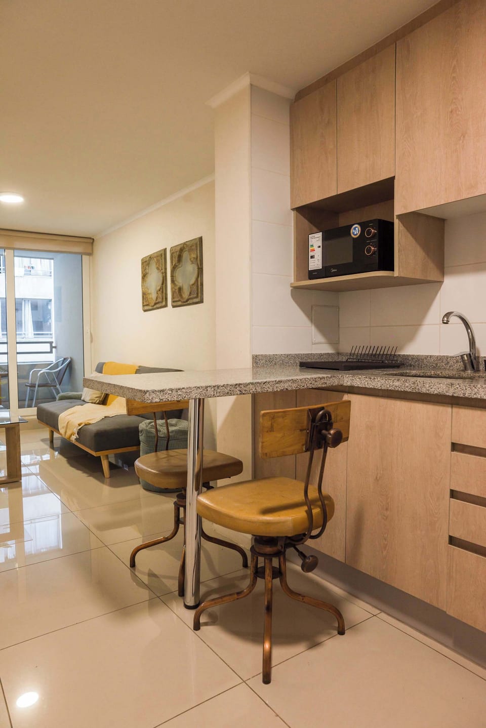 Cozy studio kitchen with modern amenities and a comfortable living space, perfect for a relaxing stay.
