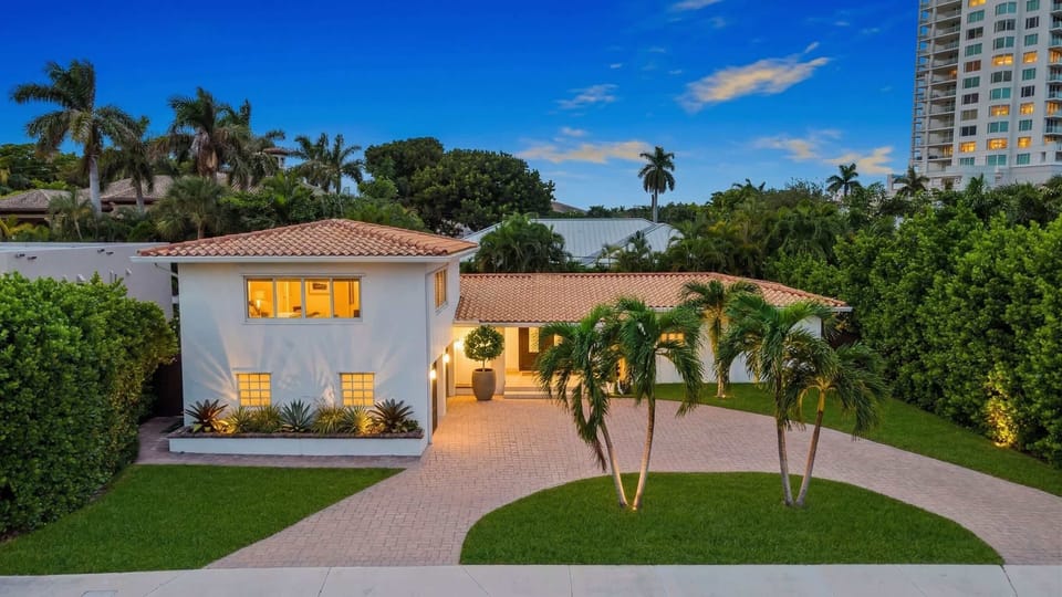 Tropical palms and a sunny driveway welcome you to Fort Lauderdale's retreat!
