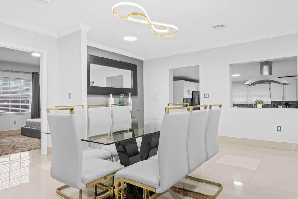 Dining Room: Elegant glass table and chic seating invite delightful meals in style!