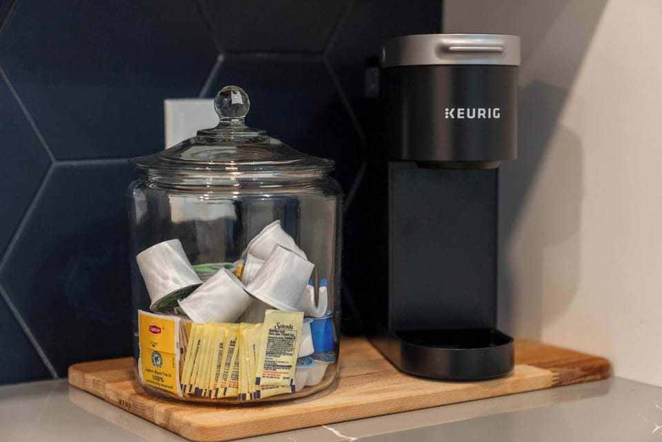 The sleek, open kitchen offers ample space & every home comfort