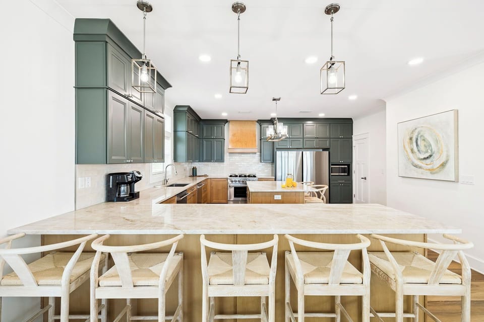 Prepare your favorite meals in this stylish kitchen, featuring modern stainless appliances, spacious marble countertops, and elegant pendant lighting—perfect for cozy dinners or gathering with loved ones.