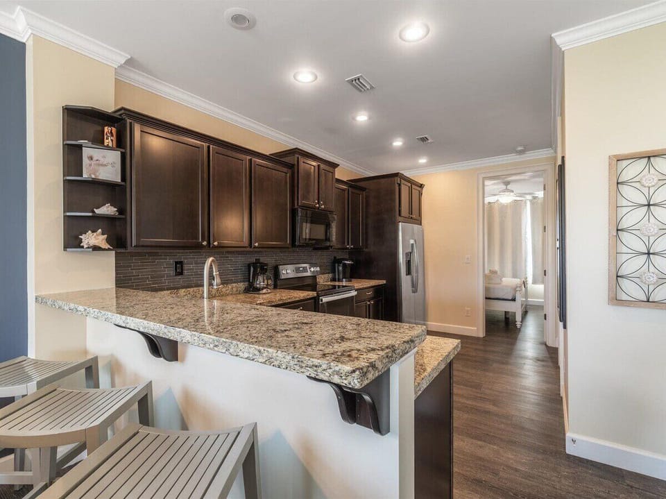 Cook in style with this sleek, modern kitchen featuring top-of-the-line stainless steel appliances.