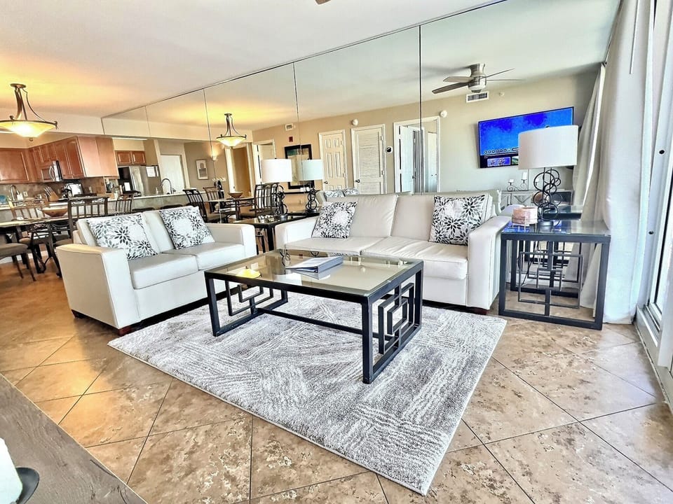 Spacious living room with a stunning Gulf view and modern furniture.