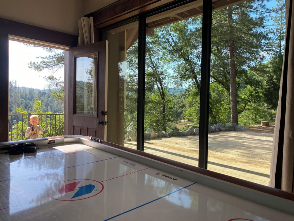 Bottom bunk room area with sliding glass doors leading to fire pit area