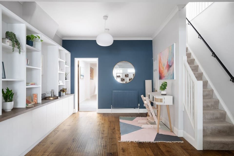A beautiful open plan lounge with a log burner, large sofa, TV, super-fast Wi-Fi, side tables, artwork, books and board games. 