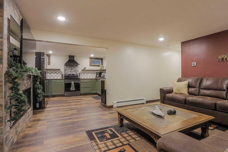 Living room and kitchen space  - Electric fireplace - 2 large couches - 55" Roku smart TV - Electric oven - Full sized fridge/freezer  - Movable kitchen island plus seating  - Unique and colorful  custom decor