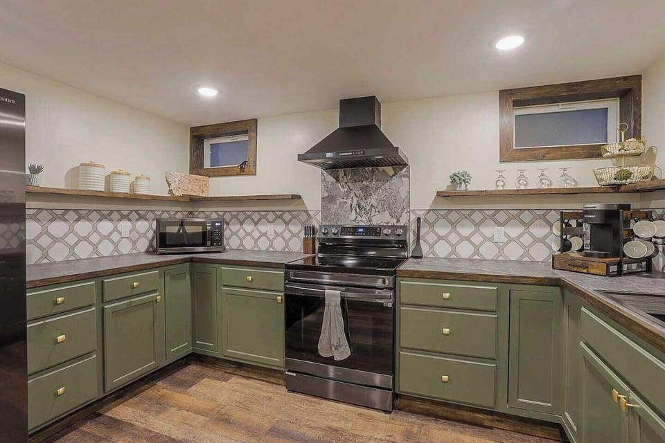 Electric range stove  - Movable kitchen island - Dishwasher  - Full sized fridge/freezer  - Keurig coffee machine  - Electric kettle - Toaster  - Microwave  - Fully stocked, all cookware and dishware  - Cooking necessities (salt, pepper)