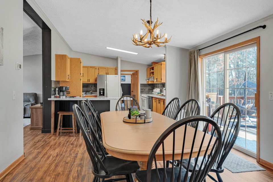 Dining Area With Table & Seating With Access To The Back Deck