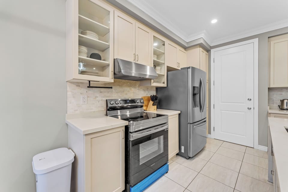Stainless steel appliances, including a fridge, oven, and microwave.