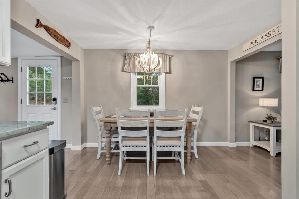 Dining area with an abundance of chairs for gathering around the table!