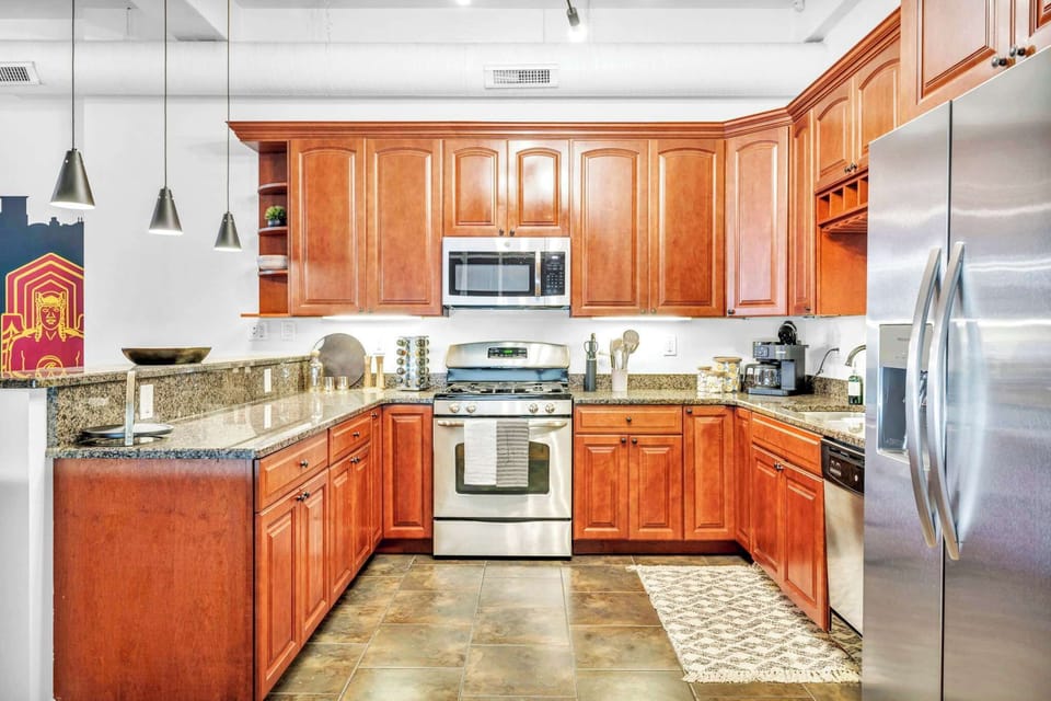 Blend of Elegance and Functionality! Featuring rich wooden cabinetry, top-of-the-line stainless steel, and ample space to keep you inspired.