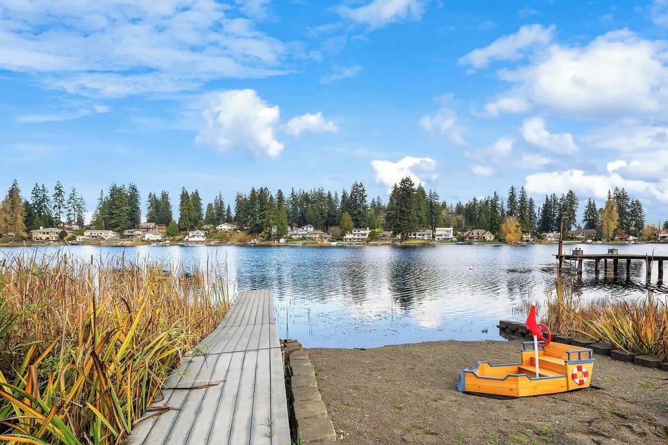 The property features a private dock extending over the tranquil lake, perfect for fishing, kayaking, or simply enjoying the serene views. It's an inviting spot to connect with nature and relax by the water.
