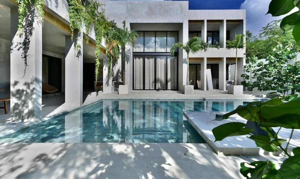 luxury villa view nestled amid tropical gardens, offering stunning views of the pool and serene surroundings.