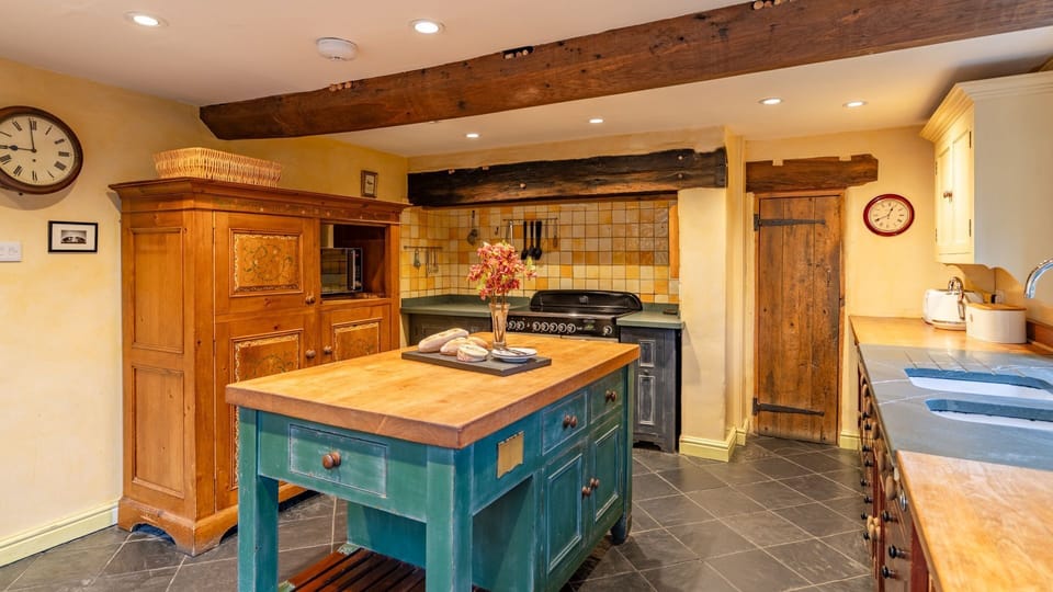 The fridge/freezer is hidden away in a decorative cabinet