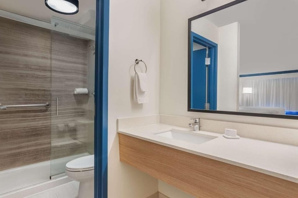 Refresh in a spotless bath with a sleek, modern vanity.