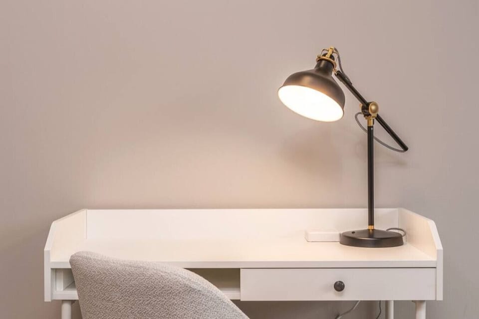 This cozy workspace with warm lighting, and a creative wall display, perfect for productivity.