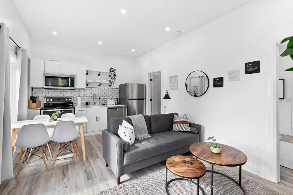 Spacious open-concept living and dining area featuring a vibrant sofa, modern furnishings, and a stylish entertainment setup—ideal for gatherings and relaxation.