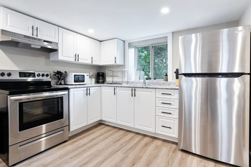 Cook with ease in this well-equipped kitchen featuring stainless steel appliances, ample cabinetry, and a stylish backsplash. Whether you're brewing coffee or preparing a gourmet meal, this space is designed for functionality and style, making every meal
