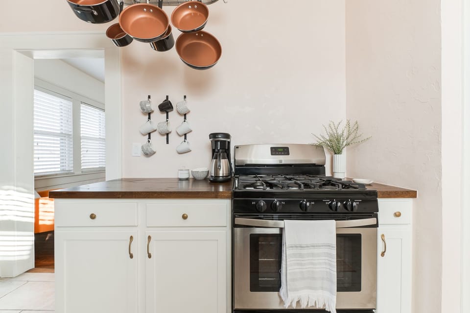 Gas stove & all the pots and pans and cookware you need. Coffee bar is all set!