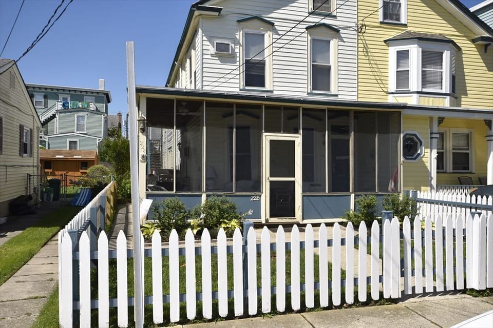Charming beachside house with a classic picket fence and a welcoming front porch, just three blocks from the beach.