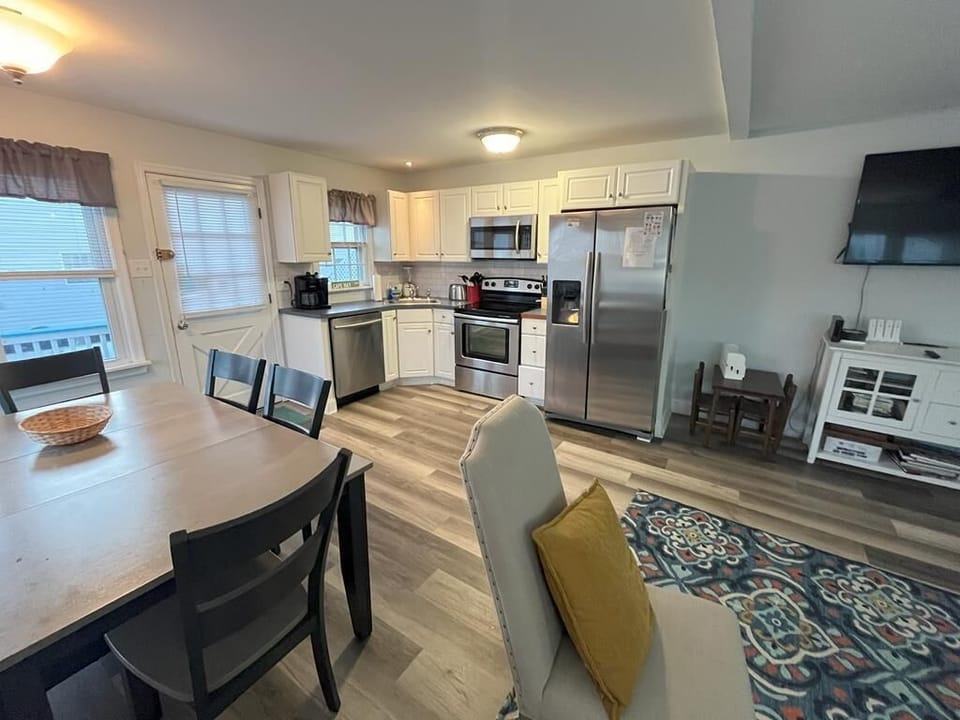 Fully equipped kitchen featuring modern appliances, ample counter space, and a dining area for family meals.