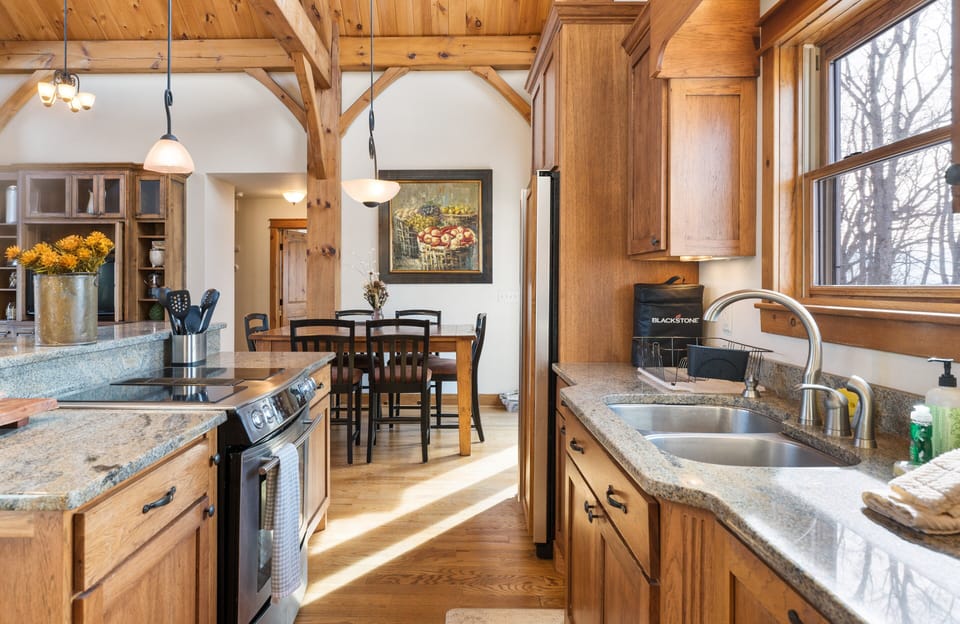 Galley Style Kitchen with Double Ceramic Top Stove, Double Basin Sink, Opens to the Dining Room