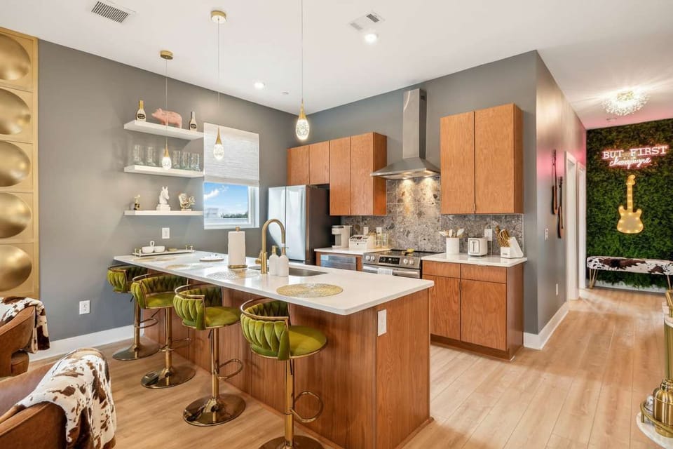 Explore this chic Nashville vacation rental, perfect for large groups or bachelorette parties! Enjoy a stylish kitchen with green bar stools and downtown views, just steps from Music City’s vibrant scene. Unwind in luxury!
