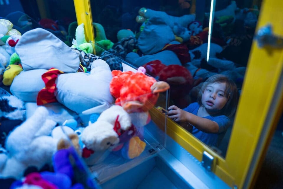 A closer look at the arcade`s colorful stash of plush prizes shows just how much fun awaits the youngest guests. A whimsical, unexpected touch that makes this home feel like its own private amusement park.