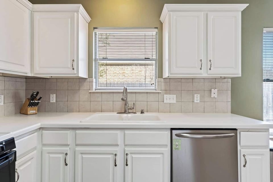 Bright kitchen sink area with clean finishes and natural light