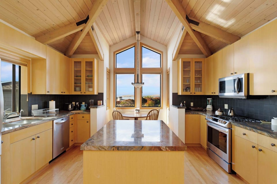 Prepare meals with ease in this thoughtfully designed kitchen, complete with a breakfast nook overlooking the sea.