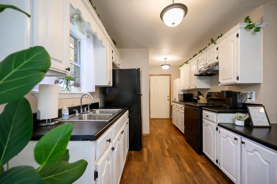 The airy kitchen offers ample space & all the comforts of home