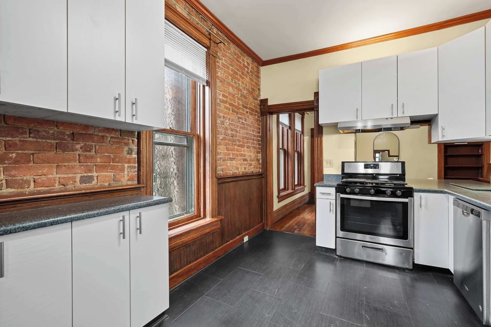 The airy kitchen offers ample space & every home comfort